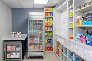 a grocery store aisle with a refrigerator at Hampton Inn & Suites-Austin Airport in Austin
