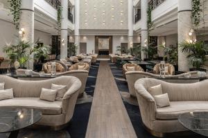a hotel lobby with couches and tables at Hilton Nicosia in Nicosia