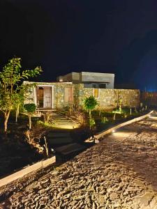 a building on a beach at night at Vanthra Vilas, Jawai - Luxury Villas with Private Pools in Bijāpur