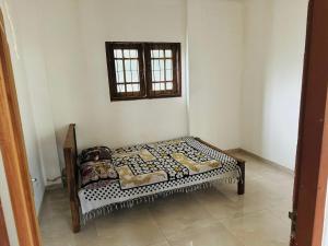 a small bed in a room with a window at Matara Villa in Matara