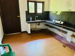a kitchen with a sink and a stove in it at Matara Villa in Matara