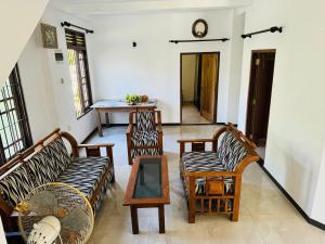 a living room with two couches and a table at Matara Villa in Matara