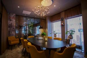 a dining room with a table and chairs and a chandelier at Scandic Karlstad City in Karlstad +51 photos