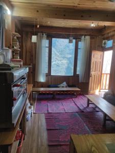a kitchen with a large window and a large rug at The Quiet Corner in Gushaini