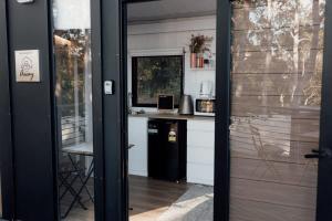 a door leading into a kitchen with a counter at Tiny Tamborine 2 by Tiny Away in Wongawallan