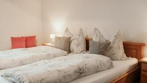 two beds sitting next to each other in a room at Haus Edelweiss in Itter