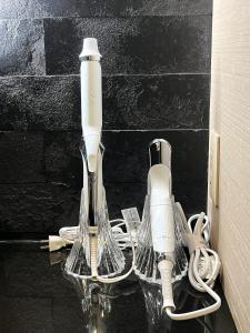 a couple of electric toothbrushes sitting on a counter at Tsumugi Tojihigashimonmae in Kyoto