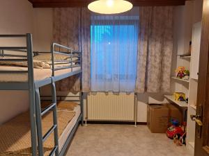 a bedroom with two bunk beds and a window at Ferienhaus mit Garten in Traiskirchen