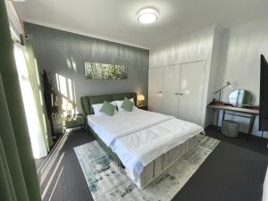 a bedroom with a large bed with white sheets at Equitice Spring Moonlight Villa - Shared Property in Perth