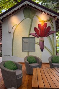 a house with a painting of a flower on it at Indigaslanda Walawwa in Bopitiya
