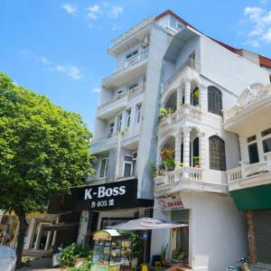 a white building with a k boss sign on it at K-BOSS Hotel in Bắc Ninh