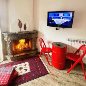 a living room with two chairs and a fireplace at CentreToni Arida in Al Arz