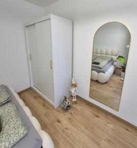 a bedroom with a bed and a mirror at Apartmán Sárka Brezno in Brezno +20 photos