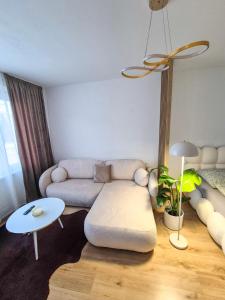 a living room with a couch and a table at Apartmán Sárka Brezno in Brezno