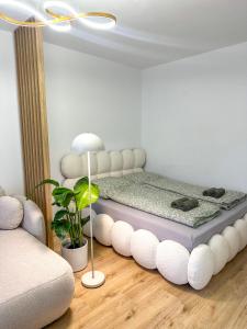 a room with a bed with a white bed frame at Apartmán Sárka Brezno in Brezno