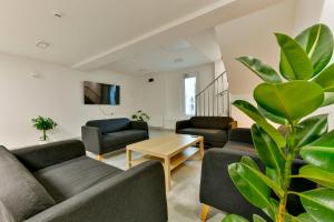 a living room with couches and a plant at Ośrodek Wypoczynkowy Caritas in Wałcz