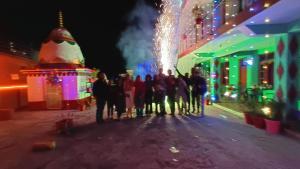 a group of people standing on a street at night at DreamCatcher & Homestay in McLeod Ganj