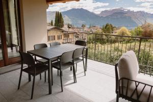 a table and chairs on a balcony with a view at Villa Elena in Menaggio +36 photos