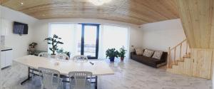 a living room with a table and chairs and a couch at Shahdag A-Frame in Qusar +36 photos