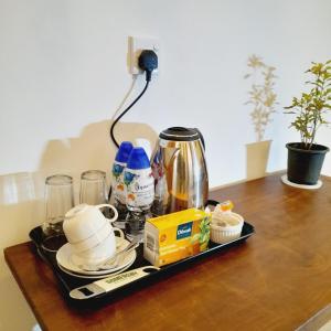 a tray with cups and other items on a table at Ashan Villa Ahungalla in Ahungalla