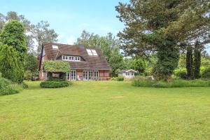a house with a large lawn in front of it at Landhaus Köhn - Ostholstein in Giekau
