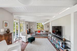 a living room filled with furniture and a tv at Landhaus Köhn - Ostholstein in Giekau