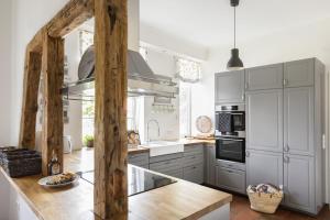 a kitchen with gray cabinets and a counter top at Pächterhaus - Ostholstein in Manhagen