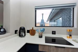 a kitchen with a sink and a window at Grey Luxury Accommodation Langebaan in Langebaan +55 photos