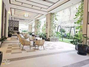 a lobby with chairs and tables in a building at Vtan Condo in Manila