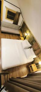 an overhead view of a bed in a room at A-Frame House บ้านเอเฟรม แดลอร์ปู in Ban Yang