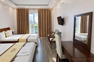 a hotel room with two beds and a window at Hotel Ngoc Anh - Van Don in Quang Ninh +36 photos