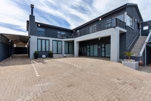 a large house with a large driveway at Grey Luxury Accommodation Langebaan in Langebaan