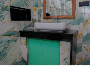 a bathroom with a sink and a mirror at Ceylon Vista in Galle