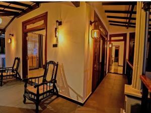 a living room with two chairs and a hallway at Ceylon Vista in Galle