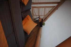 an overhead view of a bed with an orange pillow at Arjuno Chatten Valley in Punten +1 photo