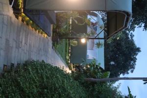 a house with a window with lights on it at Arjuno Chatten Valley in Punten