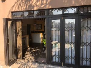 a room with sliding glass doors and a bedroom at Rapids View Cottage in Parys +5 photos
