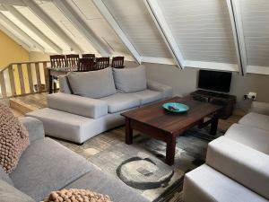 a living room with a couch and a table at Rapids View Cottage in Parys