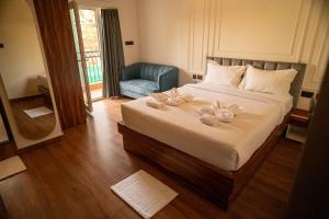 a bedroom with a bed with two stuffed animals on it at Lume Stayz in Siolim