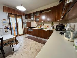 a kitchen with wooden cabinets and a white counter top at Cassiopea in Isnello