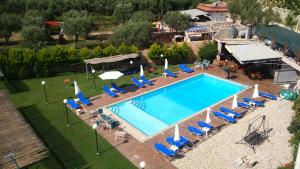 an overhead view of a swimming pool with chairs and umbrellas at Sezar's - Niko & Mimoza Qesari in Qeparo