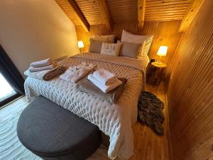 a bedroom with a large bed with towels on it at Mountain Chalet & Spa Makov Hrib in Makov Hrib