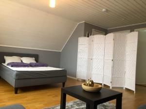a bedroom with a bed and a table in a room at Villa Tina in Hammarstrand