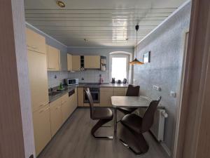 a small kitchen with a table and chairs at Pension Remenar & Lorenz in Zeithain