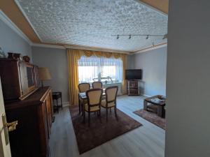 a living room with a dining room table and chairs at Pension Remenar & Lorenz in Zeithain