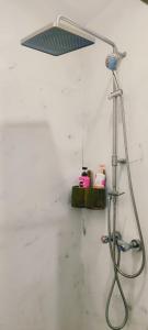 a shower with a light on a wall at A-Frame House บ้านเอเฟรม แดลอร์ปู in Ban Yang
