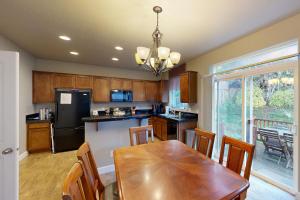 a kitchen with a wooden table and a dining room at Sundown Lagoon in Tillamook