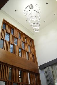 a chandelier hanging from the ceiling in a room at Sharvin Villa in Karaikal