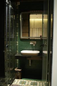 a bathroom with a sink and a mirror at Sharvin Villa in Karaikal +30 photos