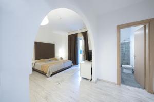 a bedroom with a bed and a bathroom at Approdo Boutique Hotel Leuca in Leuca +94 photos